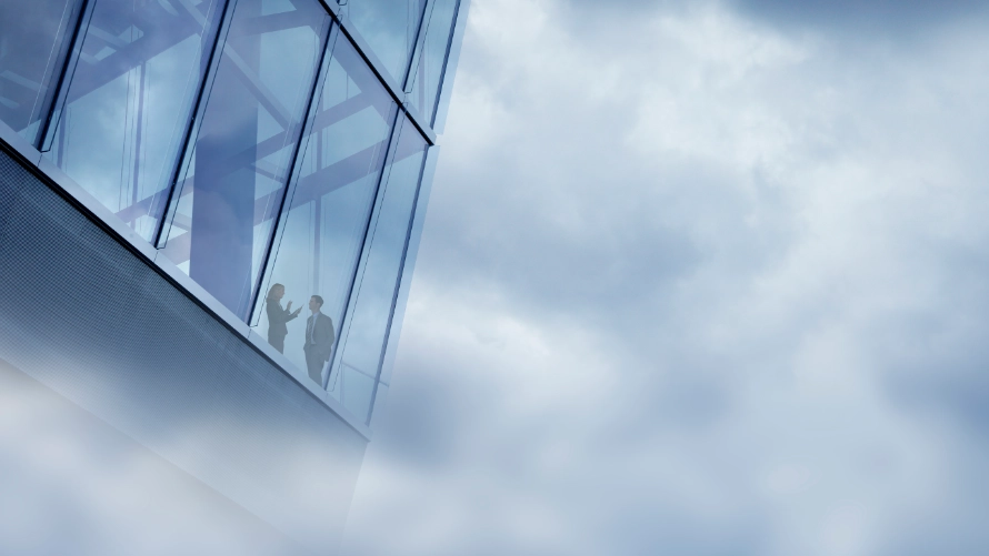 Two international workers in a high rise glass office