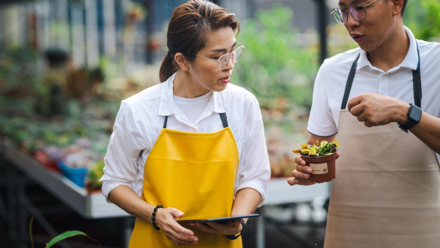 Asian agricultural workers discussing growing techniques