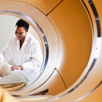 Medical scanning machine with patient and doctor in the back ground