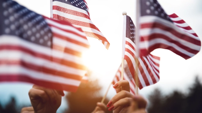 hands holding USA flags