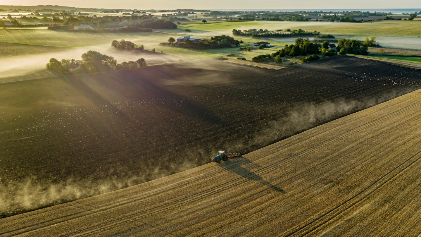 Tractor ploughing a rural field image
