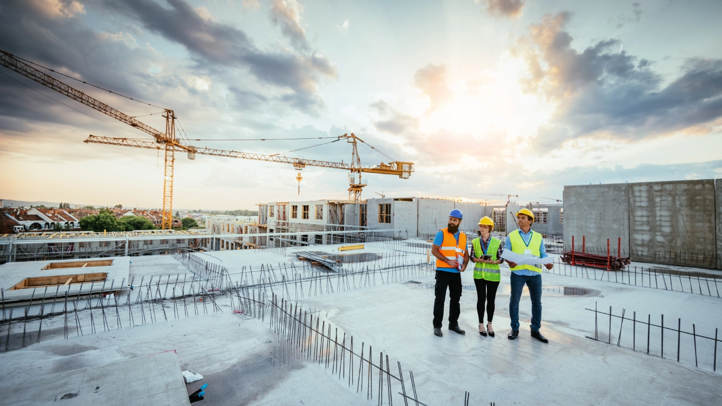 Group of construction workers on a roof top image
