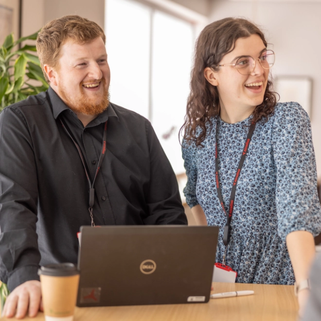 Two Atradius colleagues sharing a comment in a breakout area