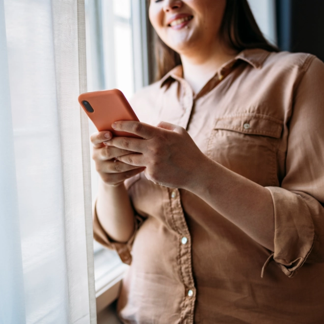 Young woman checking her mobile in the office